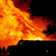 Butte county firefighters watch as flames tower over their truck at the Bear Fire in Oroville, California on Sept. 9, 2020.